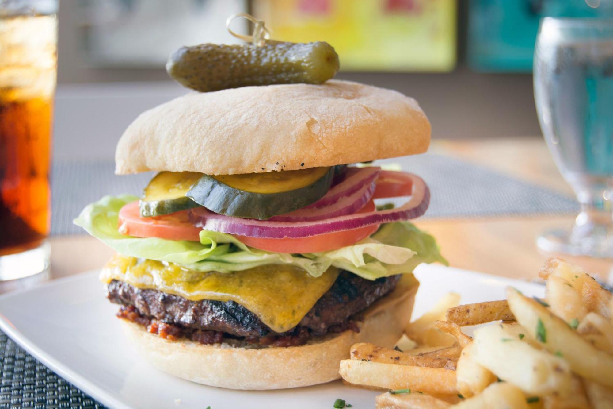 Hotel Murano Такома Экстерьер фото A cheeseburger with lettuce, tomato, onion, and pickle